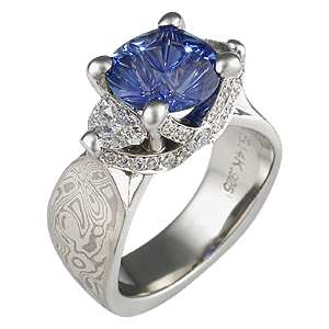 expensive-mokume-ribbon-three-stone-engagement-ring-blue-sapphire ...