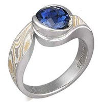 modern mokume swirl engagement ring with blue sapphire
