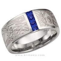 mokume wedding band with vertical blue sapphire channel