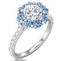 flower halo engagement ring with blue sapphires