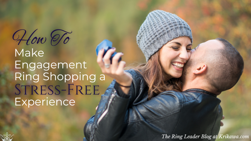 Happy couple hugging and laughing, the woman holds an engagement ring box in her hand with an autumn background.