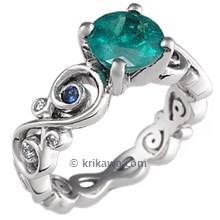 Contemporary Infinity Engagement Ring with Emerald, Blue Sapphires and Diamonds