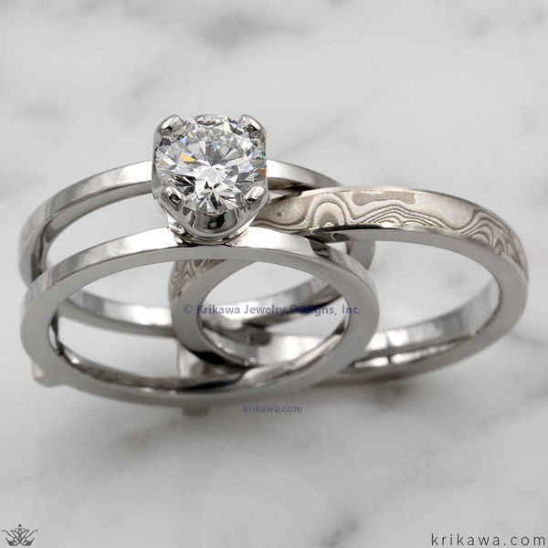 This unique contemporary engagement ring is designed to scaffold around a wedding band.