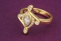 This contemporary engagement ring has antique styling with 0.22 ctw pave set diamonds and millegraining.