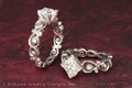 A Pair of Contemporary Infinity Engagement Rings with diamonds and ornately carved infinity symbols