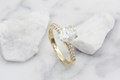 This micro-paved engagement ring has a six-claw setting.  The unique two-tone ring shown has a yellow gold head and platinum band.