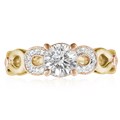 This engagement ring features infinity symbols around the band.  The infinity beneath the head has diamond pave and millegrain detail. 