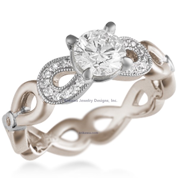 This engagement ring features infinity symbols around the band.  The infinity beneath the head has diamond pave and millegrain detail. 