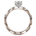 This engagement ring features infinity symbols around the band.  The infinity beneath the head has diamond pave and millegrain detail. 