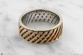 Two separate bands are perfectly fitted to weave through one another and become one permanent work of art.