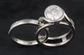 This contemporary engagement, designed to wrap around the wedding band, is comprised of mostly negative space. 