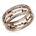 Looking for a masculine, artisan wedding band? How about a gritty ring design reflective of your lifestyle or personality? Our Barbed Wire Wedding Band is the answer. The bars of this ring have a wood-grain pattern, with the "wire" wrapped in-between.