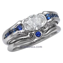 Carved Curls Engagement Ring with Oval Diamond and Tapering Blue Sapphires
