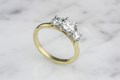 Three round stones are all that is needed in this fan-style simple engagement ring. For a unique twist, choose two metal tones for the head and shank, or keep it a uniform metal. 