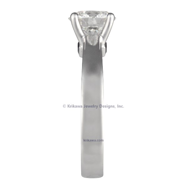 A sleek, modern band gracefully flows into a gorgeous cathedral-set solitaire gem in this lovely ring.