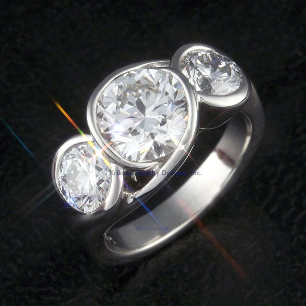 This luxurious engagement ring features the classic three-stone design with a twist!