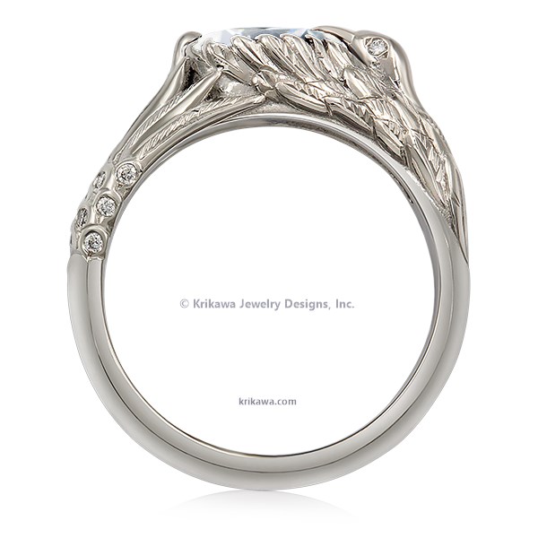  This hummingbird engagement ring is a miniature sculpture in every sense!  The band features a delicate hummingbird's wings cradling the solitaire center stone. Accent stones decorate the bird's head and tail for extra sparkle. 
