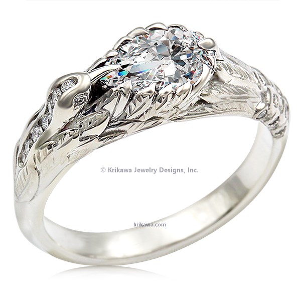  This hummingbird engagement ring is a miniature sculpture in every sense!  The band features a delicate hummingbird's wings cradling the solitaire center stone. Accent stones decorate the bird's head and tail for extra sparkle. 