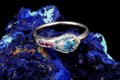 Peacock Engagement Ring with a Vivid Blue Diamond Center Stone.
