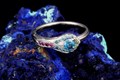 Peacock Engagement Ring with a Vivid Blue Diamond Center Stone.
