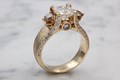 Luxurious and sculptural, this signature design features a center stone framed on either side by two additional side stones. 