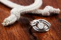 An endless knot wraps the center stone of your choice! The knot is a beautiful symbol of your eternal love and becomes the support of the semi-bezel solitaire in this organic ring design.
