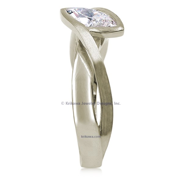 A simplified, modern version of our classic River Twist Engagement Ring this engagement ring features a solitaire stone set at an angle and suspended above a band that flows beneath like a river.
