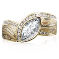 Mokume Wave Diamond Crossing Engagement Ring with blue diamond