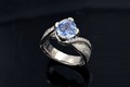 Inspired by the beauty of flowing rivers, this engagement ring boasts a mokume band with raised diamond-encrusted arms that gently embrace a central stone. Delicate curls add a touch of elegance, framing a peek-a-boo stone for a unique accent. 
