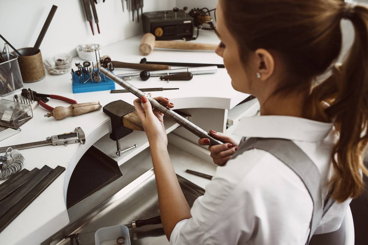A jeweler at their bench, double-checking that their ring resizing was accurate.