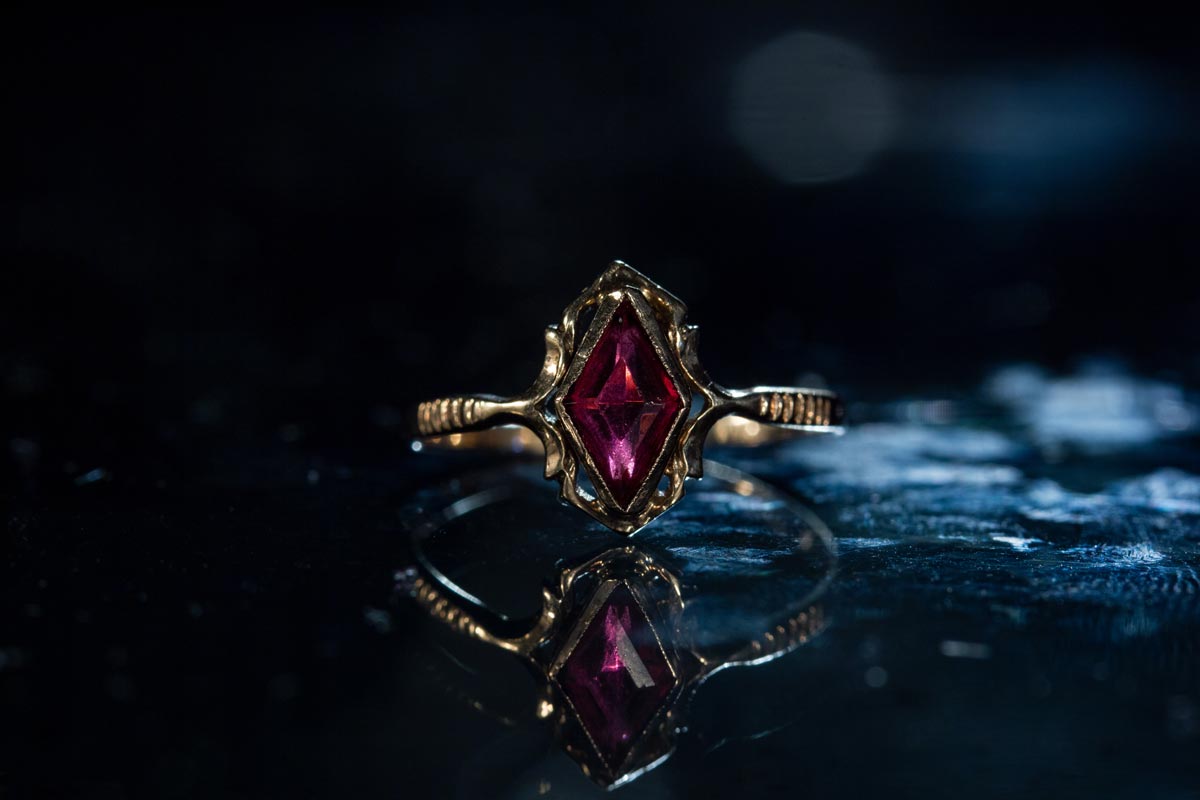 An antique-style vintage ring with a red gemstone.