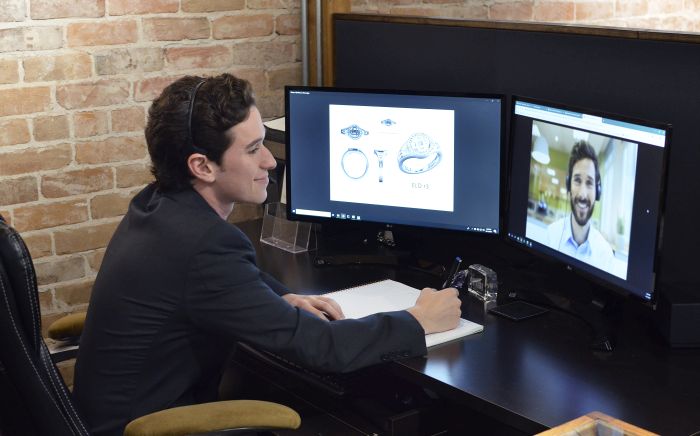 A designer working on a custom ring design via video call.