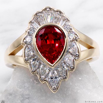 A gold ring with a central red gemstone surrounded by diamonds.