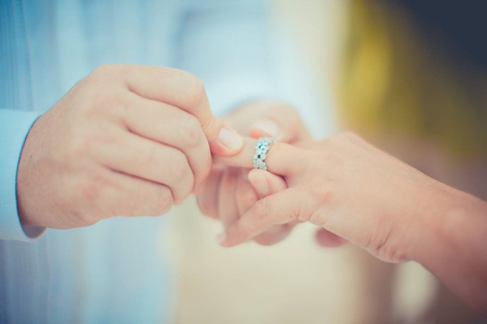 putting wedding ring on