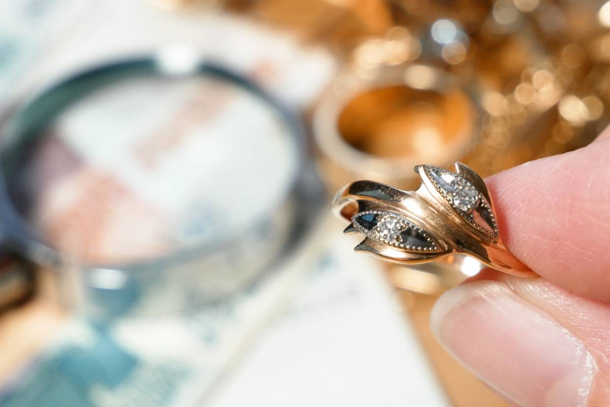 Stylized photo of a jeweler holding an engagement ring recently appraised.