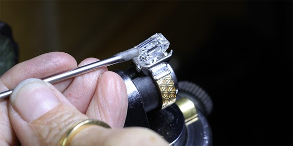 Jeweler setting a diamond at the bench